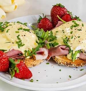 Original Montreal Eggs Benedict made with Astro Yogurt with strawberries on the side.